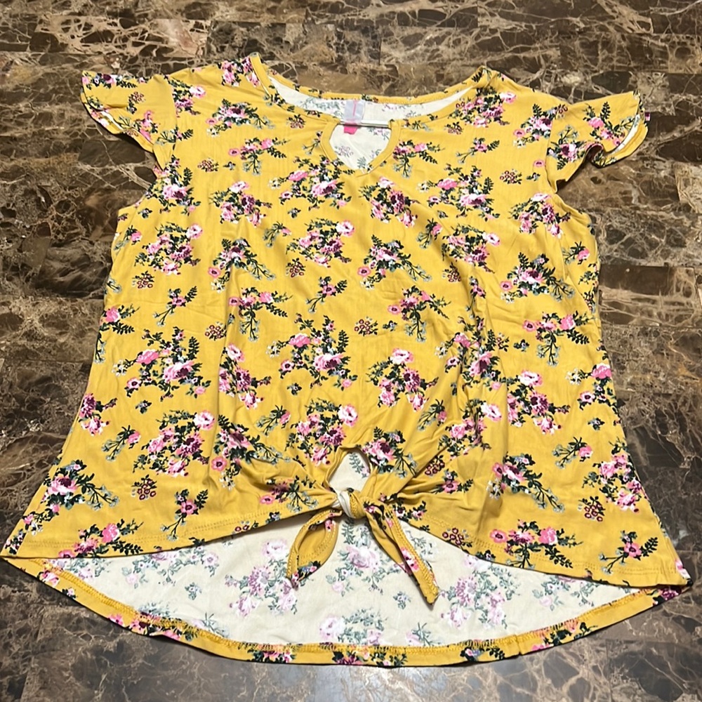 A soft, yellow/gold shirt with floral pattern